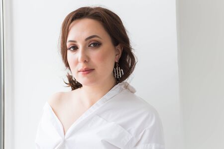 Elegant woman with earrings, close up portrait. Accessories, jewelry and bijouterie concept.の写真素材