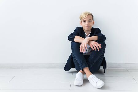 Teenage depression and puberty concept - Sad teenager portrait close up on white background.の写真素材