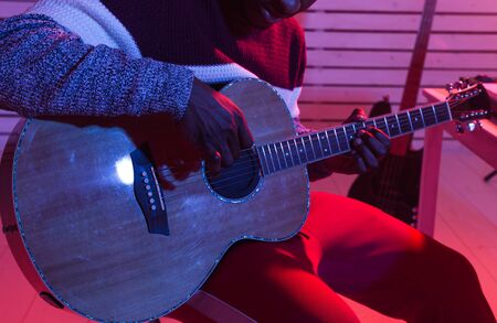 Musician and making music concept - African american male sound producer working in recording...