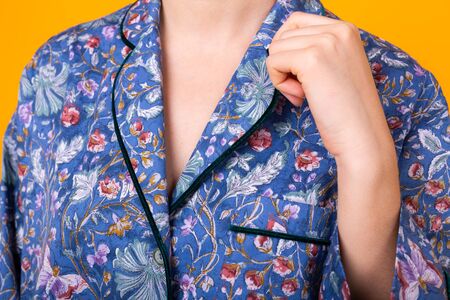 Close up of woman in home wear pajama studio lifestyle yellow background.