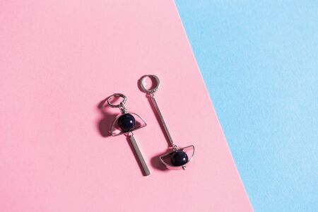 Women's Jewelry. Trendy jewelry on coloured background. Flat lay.