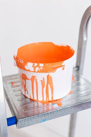 Ladder with paint in bucket near color wall indoors. Renovation and redecoration.の写真素材
