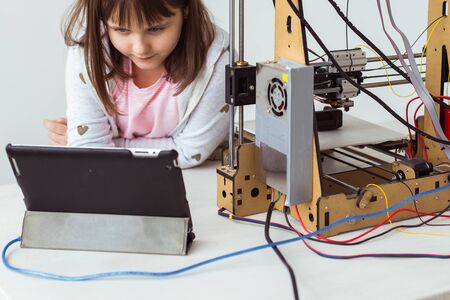Child student makes the item on the 3D printer. School, technologies and science concept.の写真素材