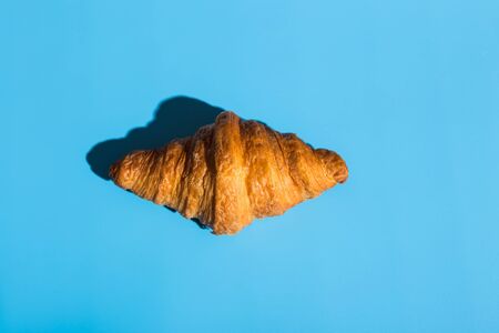 Bakery products baked croissant. Blue background, top view. Pop art style. Delicious and food concept.の写真素材