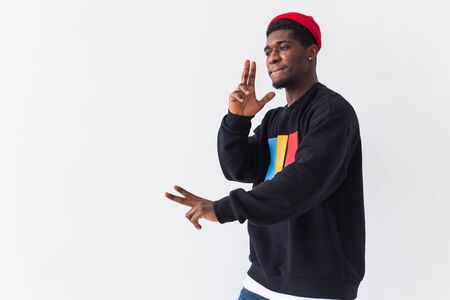 Youth street fashion concept - Portrait of confident sexy black man in stylish sweatshirt on white background with copy space.の写真素材