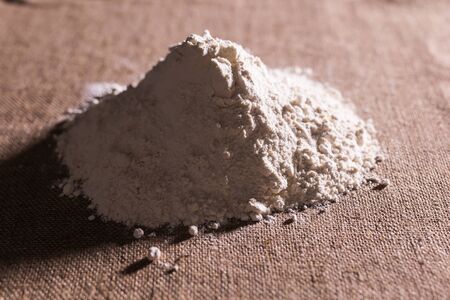 White flour on textile background texture photoの写真素材