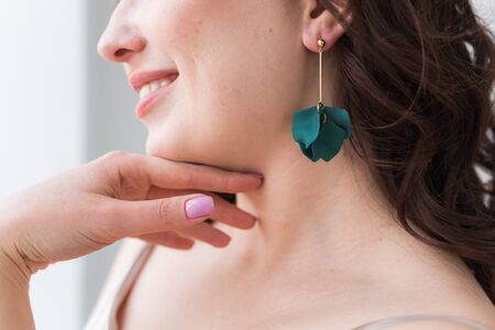 Elegant woman with earrings, close up portrait. Accessories, jewelry and bijouterie concept.