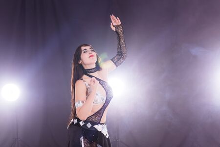 Spirituality dance. Beautiful sexy woman with luxury glossy eastern make-up dancing tribal fusion....