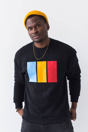 Youth street fashion concept - Portrait of confident sexy black man in stylish sweatshirt on white...