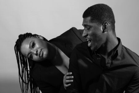 Funny portrait of young african american man and woman. Black and white photoの写真素材