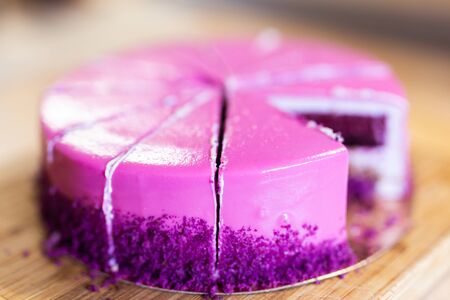 Pink and violet birthday cake without one piece. Dessert, holidays and delicious concept.の写真素材