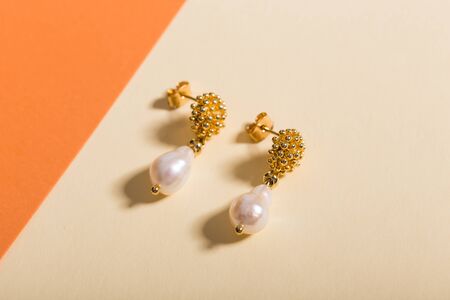Womens Jewelry. Trendy jewelry on coloured background. Flat lay, top view.の写真素材