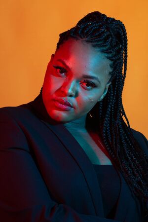 Portrait of beautiful young African American woman with afro and glamour makeup. Studio shot.の写真素材