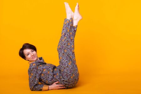 Excited young woman with black hair in home wear pajama, widely smiling having fun. Isolated on...
