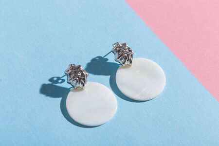 Womens Jewelry. Trendy jewelry on coloured background. Flat lay, top view.の写真素材