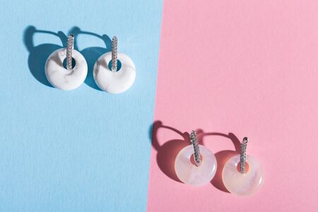 Top view of fashion jewelry and accessories on bright color background. Luxurious jewelry bijouterie and trendy.の写真素材