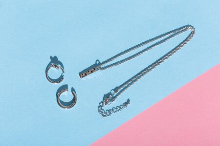 Womens Jewelry. Trendy jewelry on coloured background. Flat lay, top view.の写真素材