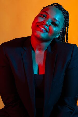 Close up portrait of Fashion young american African girl woman. Neon light.