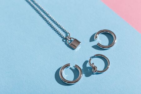 Womens Jewelry. Trendy jewelry on coloured background. Flat lay, top view.の写真素材
