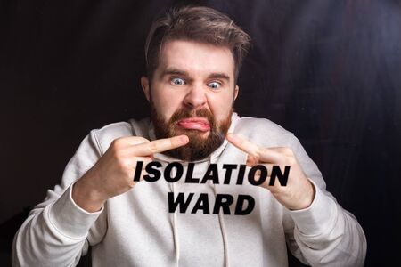 Hospital quarantine or isolation of crazy patient standing alone in room. Coronavirus COVID-19 Pandemic, Outbreak Efforts prevent virus spreading hazard controls concept.の写真素材