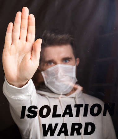 Man in respiratory mask showing stop gesture. Guy show stop gesture. Stop coronavirus or covid-19...
