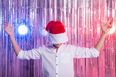 Cute funny santas helper dancing on shiny background. Christmas holidays concept.の写真素材
