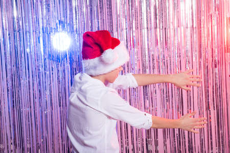 Cute funny santas helper dancing on shiny background. Christmas holidays concept.の写真素材