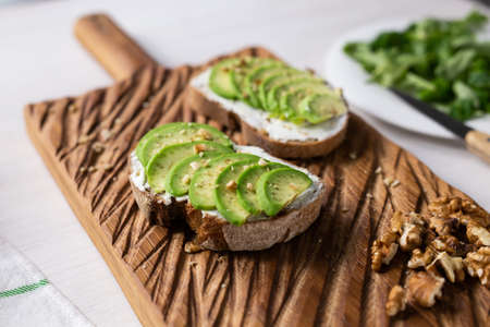 sliced avocado on toast bread with nuts