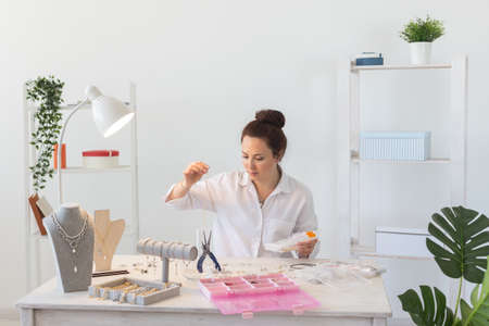 Professional accessories designer making handmade jewelry in studio workshop. Fashion, creativity...