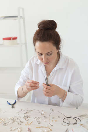Professional accessories designer making handmade jewelry in studio workshop. Fashion, creativity...