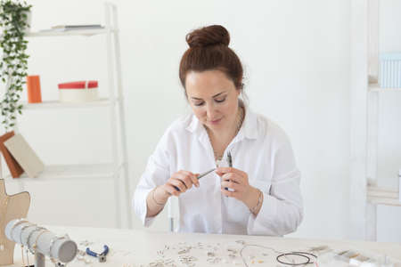 Professional jewelry designer making handmade jewelry in studio workshop. Fashion, creativity and handmade conceptの写真素材