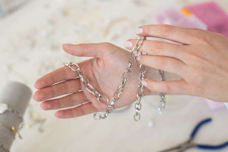 Professional jewelry designer making handmade jewelry in studio workshop. Fashion, creativity and...
