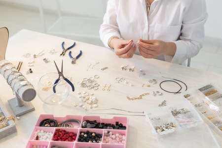 Professional jewelry designer making handmade jewelry in studio workshop close up. Fashion, creativity and handmade conceptの写真素材