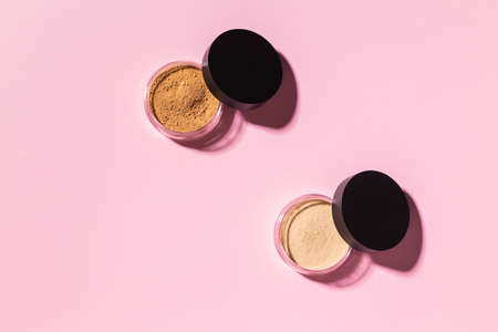Mineral powder foundation isolated on a pink background. Eco-friendly and organic beauty productsの写真素材