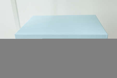 Blue gift shopping box standing on shelf. Christmas, Birthday day and present concept.の写真素材