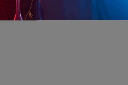 Symbol of Halloween. Jack-o-lantern on a dark background and artificial skull. Halloween card. Lamp in decorations. Background.の写真素材