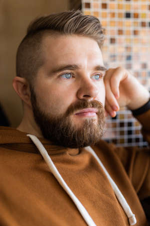 Close-up portrait of a brutal bearded man. Gen z guy portrait lifestyle.の写真素材