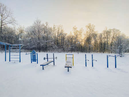 Winter sunset in snow covered park. Season and cold weather conceptの写真素材
