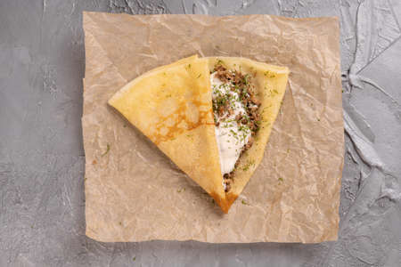 Pancakes stuffed with Bolognese filling minced beef pepper garlic and with bechamel sauce . Crepe is dish french cuisine top viewの写真素材