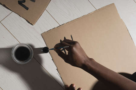 Black lives matter and fight against racism and write sign and words on cardboard - protest concept...