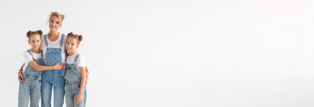 family and children concept - twin sisters with their mom on white background banner with copy space...