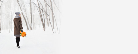 Banner attractive young woman in wintertime outdoor copy space. Christmas timeの写真素材
