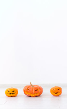 Banner Jack-o-lantern carved pumpkin on light wall background with copy space, autumn and halloween home decor  storiesの写真素材
