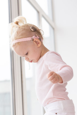 Cochlear implant for baby. Deaf child with hearing aid. Health care and medicine technology and...