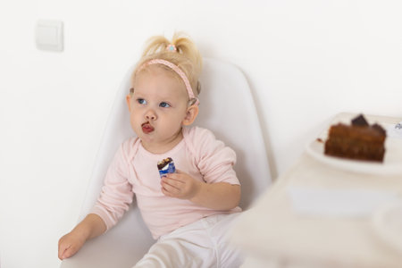 Baby with cochlear implants at home. Deafness and medical technology concept.の写真素材