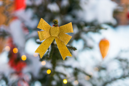 Christmas tree with golden bow and with blurred background copy space - winter holidays and decoratingの写真素材