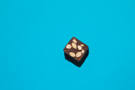 Protein date fruit candy bar fitness with nuts top view on blue background with copy space and place...