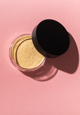 Mineral powder foundation isolated on pink background top view. Eco-friendly and organic beauty productsの写真素材