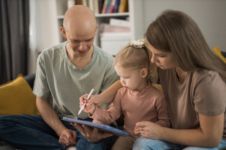 Cochlear implant system. Installation cochlear implant on child girl ear for restores hearing. Kid hears after hear return to normalの写真素材