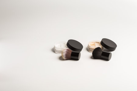 Mineral makeup powder twist seal sifter isolated on white background with brush copy space. Many beige foundation powder. Skin tone face cosmetic product sampleの写真素材